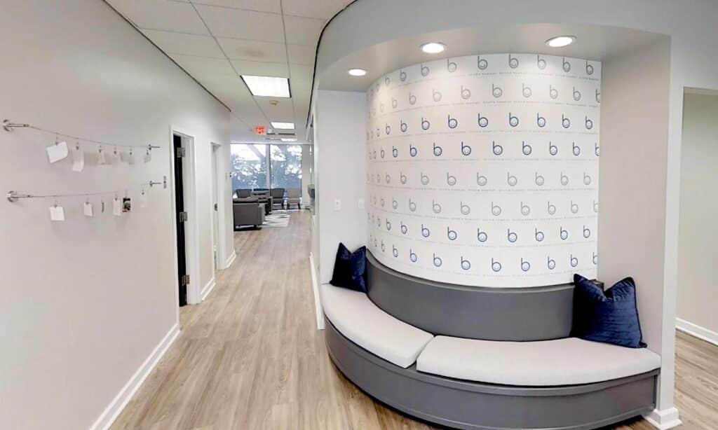 The branded hallway and logo wall patients walk down at Brodie Bowman Orthodontics in Fort Walton Beach