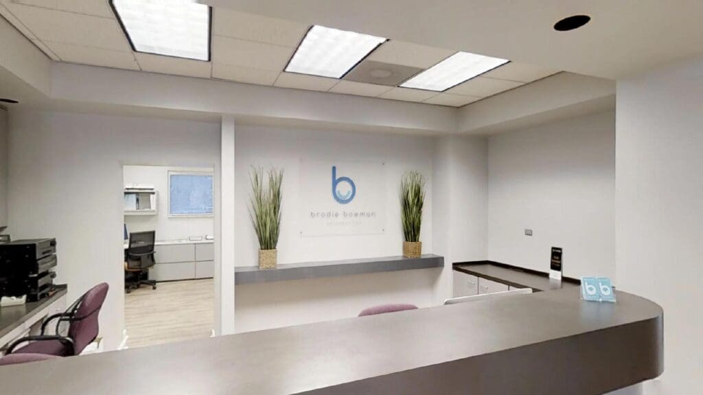 The reception desk and logo wall at Brodie Bowman Orthodontics in Fort Walton Beach