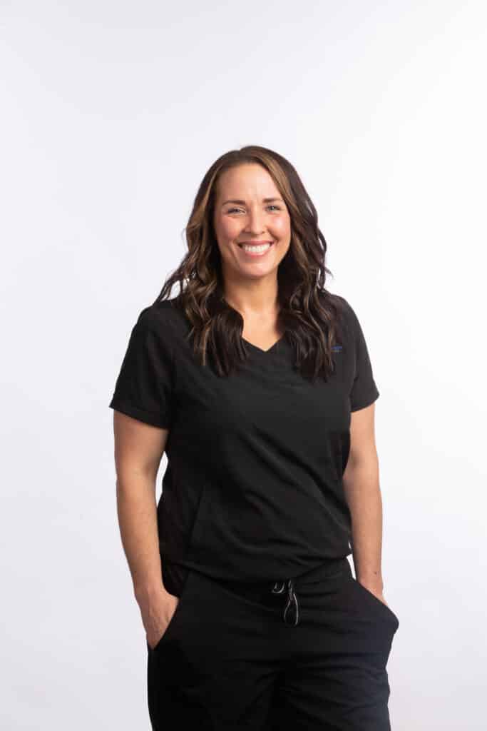 Ashely, orthodontic clinical team member at Brodie Bowman Orthodontics, smiling in black scrubs