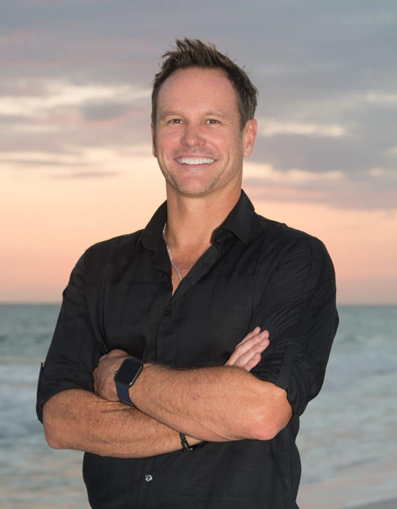 Dr. Brodie Bowman, orthodontist in Fort Walton Beach, FL, on the beach at sunset