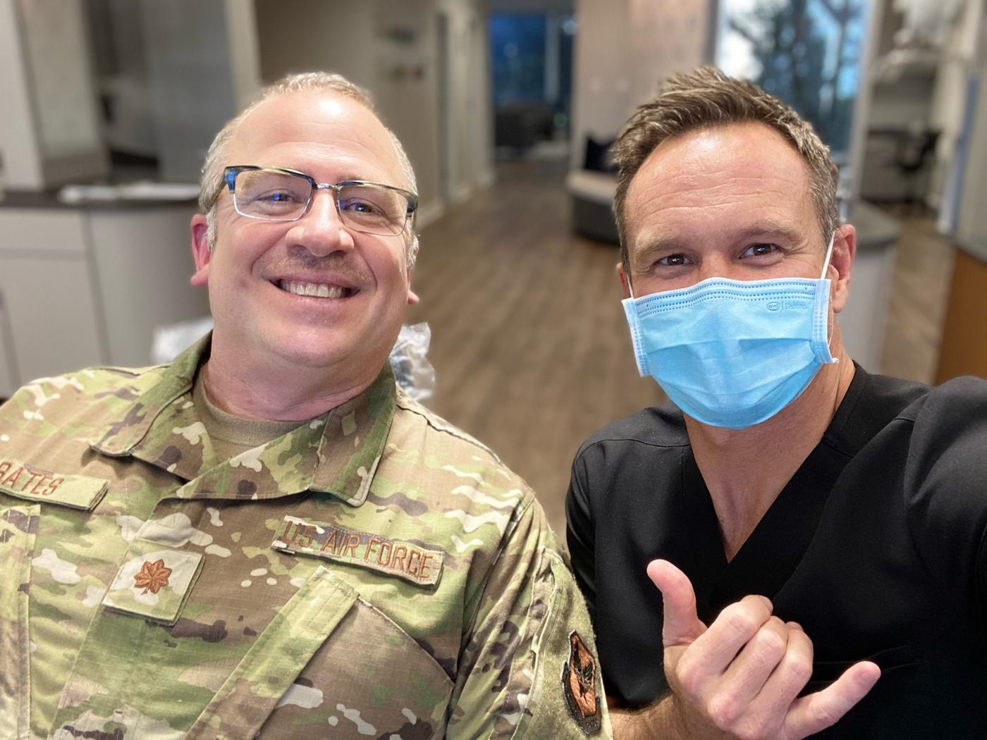 An Air Force major in uniform taking a selfie with Dr. Bowman in the Brodie Bowman Orthodontics office